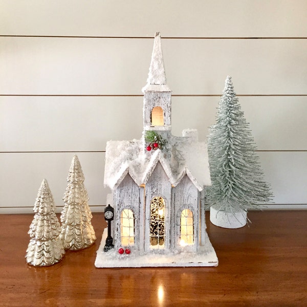 Decorated shabby rustic weathered wooden church, LED warm clear lights, Christmas display decoration, old fashioned vintage village holiday