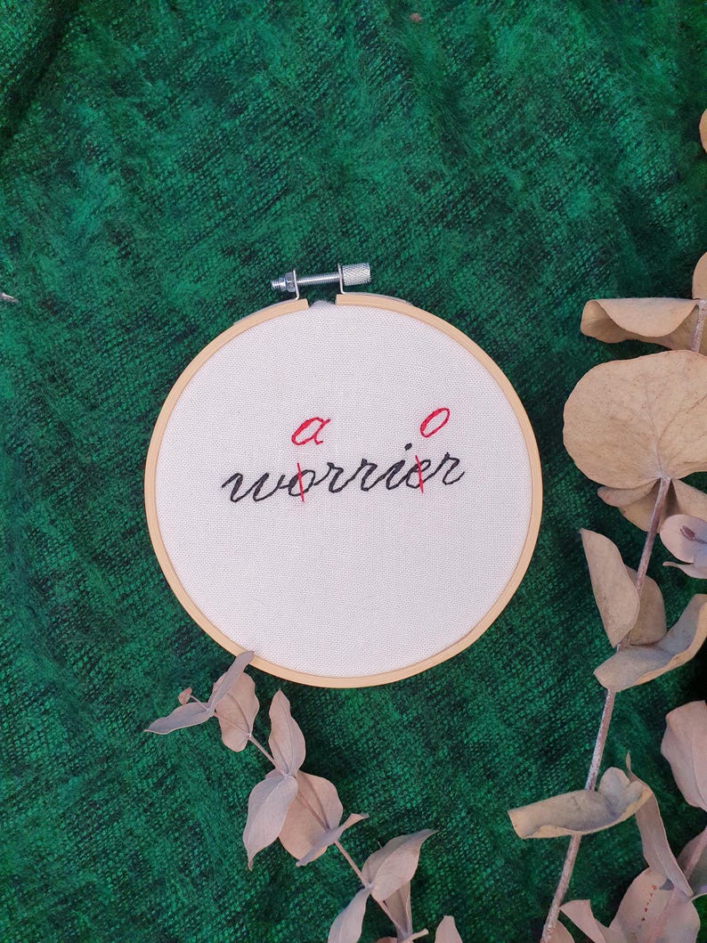 May include: A white ceramic mug with a colorful floral design. The mug features a variety of flowers in shades of pink, purple, and yellow, with green leaves. The handle is also white.