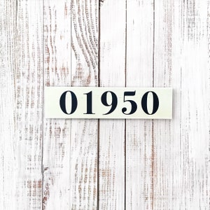 May include: A white wooden sign with black numbers reading "01950" against a white woodgrain background.