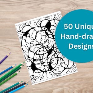 May include: A black and white abstract design on a white paper, with the text "50 Unique Hand-drawn Designs" in a teal circle. Colored pencils in blue, green, and purple are scattered on a wooden surface.