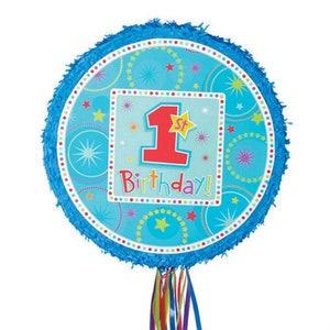 May include: Blue and red 1st birthday party pinata with a blue background and colorful stars and circles. The pinata has a string hanging from the bottom.