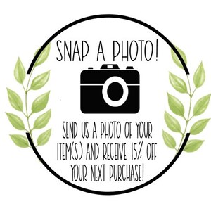 May include: A black and white illustration of a camera with green leafy branches on either side. The text reads "SNAP A PHOTO! SEND US A PHOTO OF YOUR ITEM(S) AND RECEIVE 15% OFF YOUR NEXT PURCHASE!"