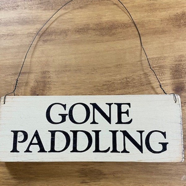 Wood sign saying " gone paddling" antique white wood with black lettering