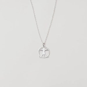 Stainless steel Vitruvian man symbol with silver plated necklace. 18 inch chain.