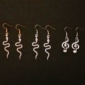 Bejeweled Reputation snake earrings with diamante in silver or gold tone with plated hooks or silver tone bejeweled treble clef. Love story.