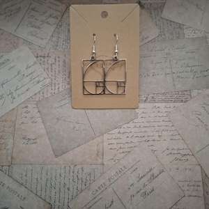 Stainless steel Fibonacci golden spiral earrings with silver plated hooks.