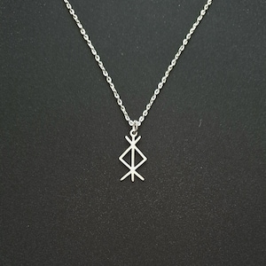 May include: A silver chain necklace with a pendant featuring the Vegvisir symbol, a Norse directional symbol.