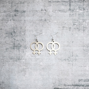 Double venus silver plated drop earrings.