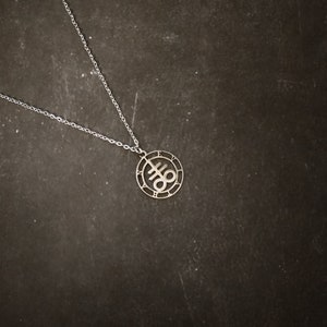 Stainless steel Leviathan cross symbol with silver plated necklace. 18 inch chain.