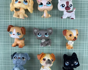 May include: Nine plastic toy dogs in various breeds and colors. The dogs are all sitting or standing and have painted eyes and noses.