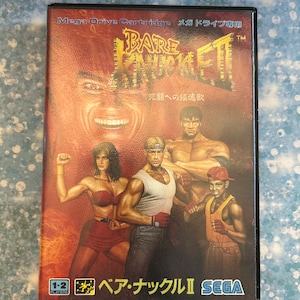 May include: A Sega Mega Drive game cartridge for the game Bare Knuckle II, also known as Streets of Rage 2. The cartridge is red and black with a picture of the characters from the game on the front. The text on the front of the cartridge reads "Bare Knuckle II" and "Sega".