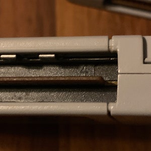 May include: Close-up of a gray Nintendo 64 game cartridge with a black label and the number "41" printed on it.