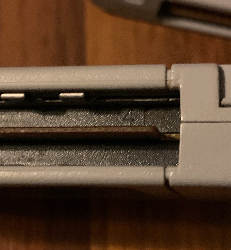 May include: Close-up of a gray Nintendo 64 game cartridge with a black label and the number "41" printed on it.