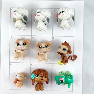 May include: Nine small plastic toy figures, including a white poodle, a brown and white bulldog, a monkey, a frog, and a brown dog. The figures are arranged in a grid on a white background.