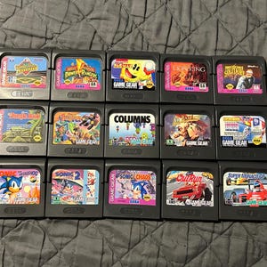 May include: A collection of 16 Sega Game Gear cartridges, including titles such as "Sonic the Hedgehog", "Sonic 2", "Columns", "Super Monaco GP", "Out Run", "Jungle Book", "Lion King", "Power Rangers", and "Sonic Chaos".