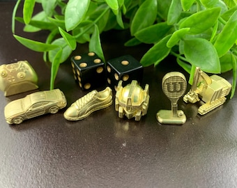 Sechs Empire Edition - Monopoly Golden Tokens – Tennisschläger, XBox Controller, mustang, Puma Sneaker, Caterpillar, Trafo Kopf