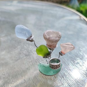May include: A set of three ceramic mugs with a speckled, matte finish in cream, light grey, and dark grey. Each mug has a simple, minimalist design and a rounded handle.