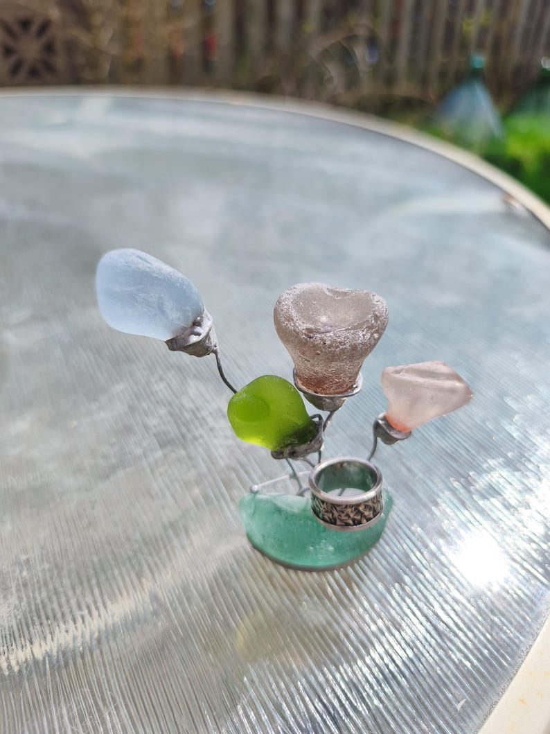 May include: A set of three ceramic mugs with a speckled, matte finish in cream, light grey, and dark grey. Each mug has a simple, minimalist design and a rounded handle.