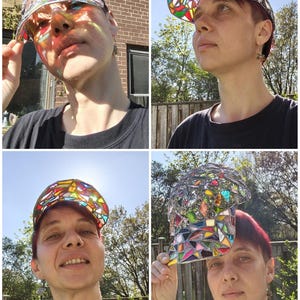 May include: A unique baseball cap with a stained glass design. The cap features a mosaic of colorful glass pieces in various shapes and sizes, creating a vibrant and eye-catching pattern. The cap's brim and crown are made of a silver material.