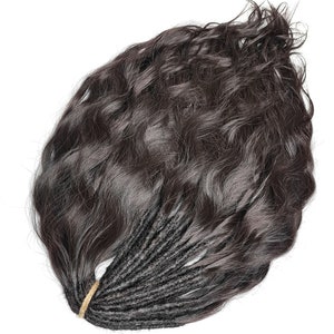 May include: A bundle of dark brown human hair extensions with a wavy texture. The hair is tied together with a brown elastic band.
