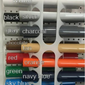 May include: A display of paint samples in various colors, including white, black, silver, gray, charcoal, chocolate, tan, red, orange, green, navy blue, sky blue, and royal blue.
