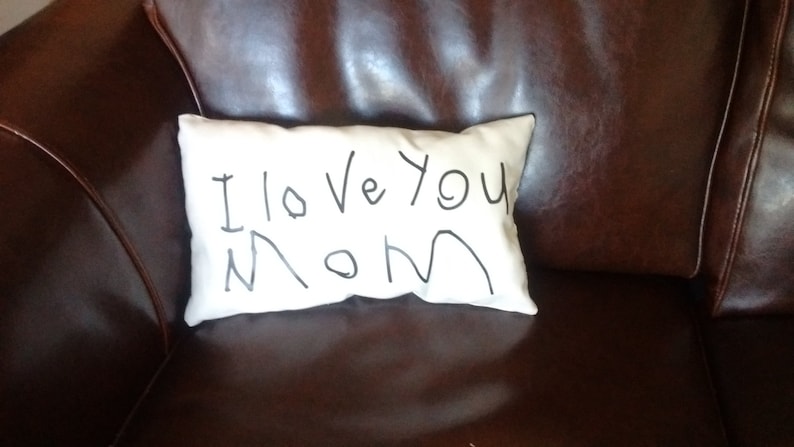 May include: A white pillow with the words "I love you Mom" written in black marker.