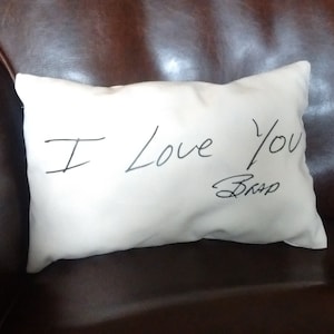 May include: White pillow with the handwritten message "I love you" and a signature that says "Bro."