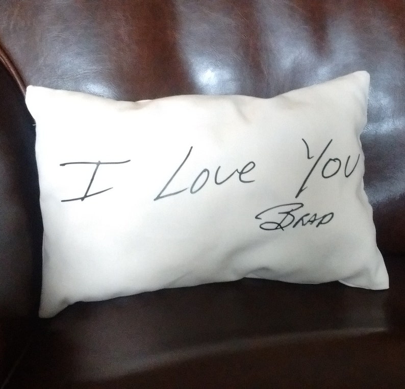 May include: White pillow with the handwritten message "I love you" and a signature that says "Bro."