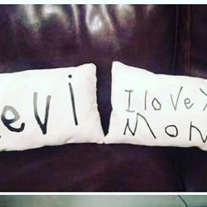 May include: Two white pillowcases with black marker writing. One pillowcase says "Levi" and the other says "I love you Mom".