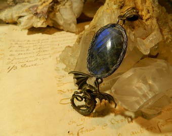 Labradorite in a cocoon of leather and her dragon pendant.