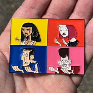 May include: A four-panel enamel pin featuring four cartoon characters with different expressions. The characters are in a grid pattern with yellow, red, blue, and pink backgrounds. The characters are a woman with black hair, a woman with red hair, a man with brown hair, and a man with black hair.