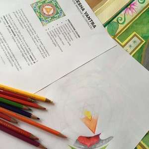 May include: A printable coloring page featuring a Ganesha Yantra, a geometric design believed to remove obstacles. The page includes instructions for coloring the design with specific colors, including gold, yellow, orange, red, green, and white.