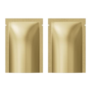 May include: Two gold-coloured, foil-like pouches with a textured, light brown border. Each pouch has a small notch at the top and a circular marking near the bottom. The pouches are likely for single-use products.