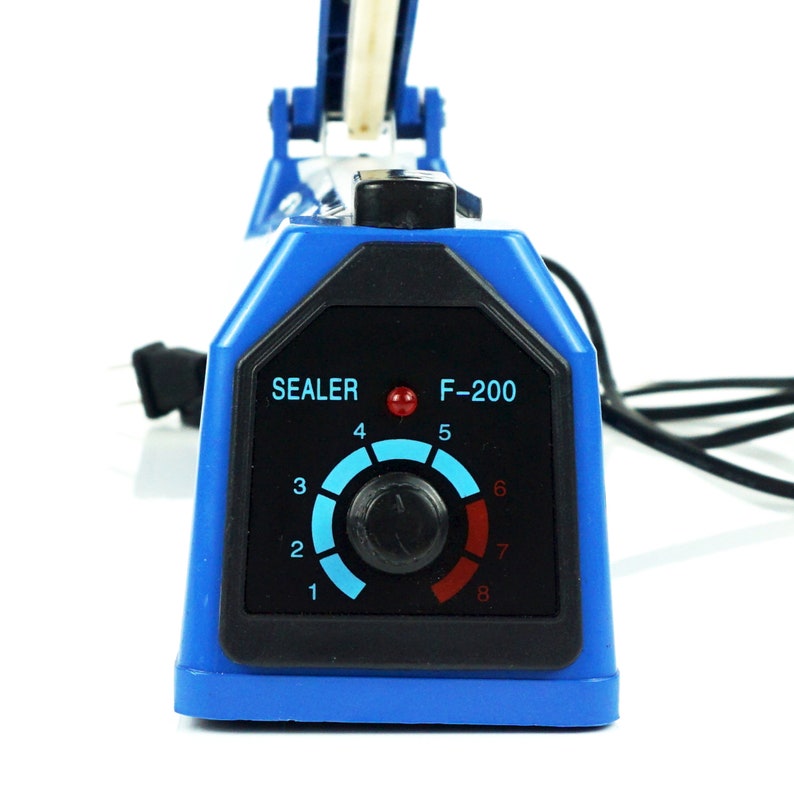 May include: Blue and black electric heat sealer with a temperature control dial labeled "SEALER F-200" and numbered 1 through 8. The dial has a red indicator light.