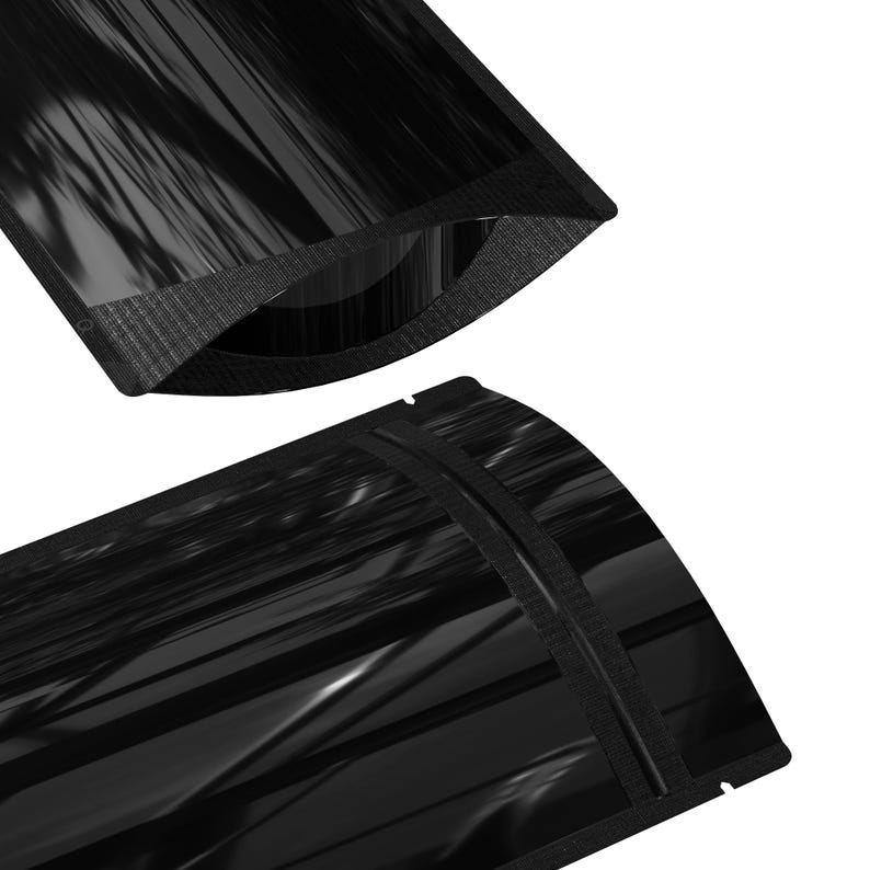 May include: Two black stand-up pouches with a heat-sealed zipper closure. The pouches are made of a shiny, metallic material.