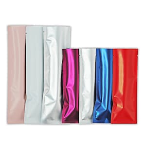 May include: Seven stand-up pouches in various colors, including pink, silver, purple, white, blue, and red. The pouches are made of a shiny, metallic material.