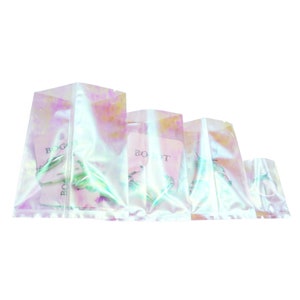 May include: Four iridescent clear plastic bags with a zipper closure. The bags are arranged in descending size order. Each bag contains a small silver earring and a white card with the word "BOGIT" printed on it.
