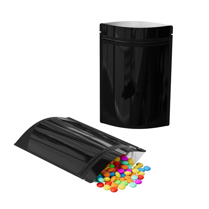 May include: Two black stand-up pouches with a silver zipper. One pouch is empty and the other is filled with colorful candy.