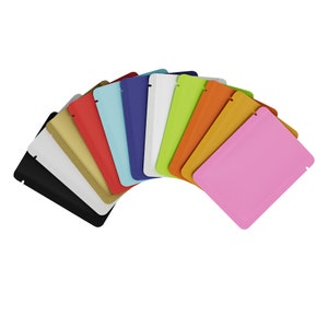 May include: A variety of colors of stand-up pouches, including black, white, gold, red, light blue, dark blue, green, orange, yellow, and pink.