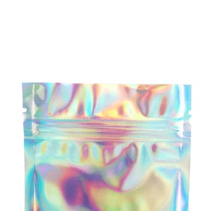 May include: A holographic iridescent silver pouch with a zipper closure. The pouch is made of a shiny, reflective material.