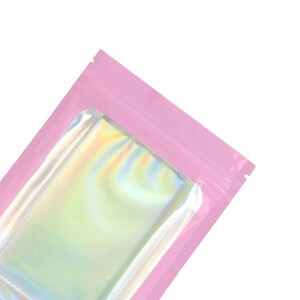 May include: A pink resealable pouch with a clear iridescent window.