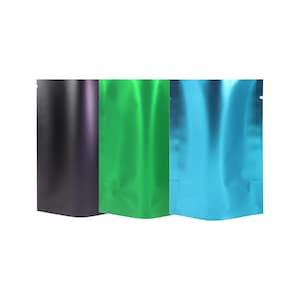May include: Three metallic pouches in black, green, and blue. The pouches are standing upright and have a shiny, reflective surface. The pouches are sealed at the top and have a small notch for easy opening. The background is plain white.