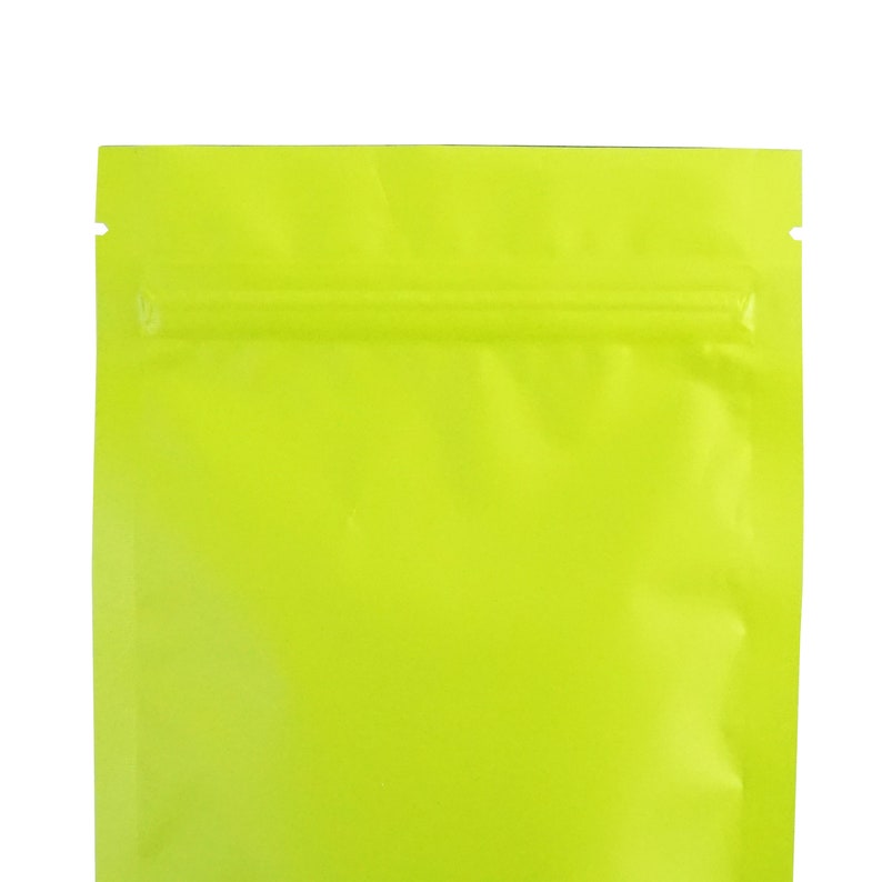 May include: A bright yellow stand-up pouch with a zipper closure. The pouch is made of a shiny, metallic material.