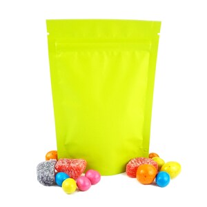 May include: A bright green stand-up pouch with a zipper closure. The pouch is filled with colorful candies, including red, orange, yellow, green, blue, and purple.
