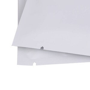 May include: Two white plastic bags with a small hole in each bag.