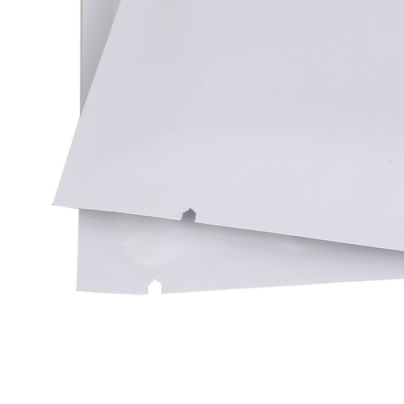 May include: Two white plastic bags with a small hole in each bag.