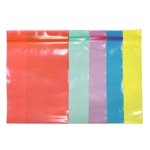 May include: Five clear plastic zipper bags in different colors: red, green, purple, blue, and yellow.