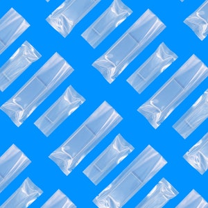 May include: A repeating pattern of clear plastic bags on a bright blue background. The bags are all the same size and shape, and they are arranged in a diagonal pattern.