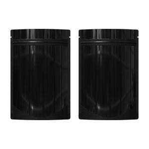 May include: Two black stand-up pouches with a zipper closure. The pouches are made of a shiny, metallic material.