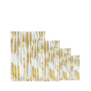 May include: Four clear plastic bags with a white background and gold brushstroke pattern. The bags are arranged in a row from largest to smallest.